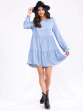 Long sleeve tiered chambray tunic top with long sleeves and a tiered loose fit ￼