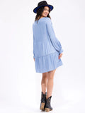 Long sleeve tiered chambray tunic top with long sleeves and a tiered loose fit ￼