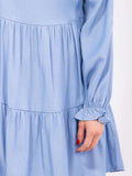 Long sleeve tiered chambray tunic top with long sleeves and a tiered loose fit ￼